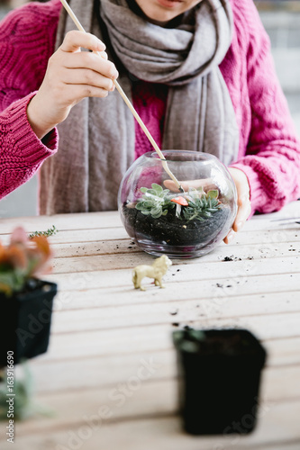 Woman making terrarium