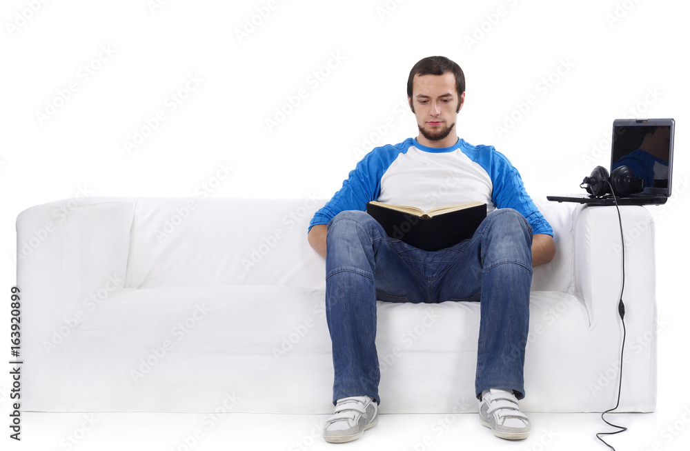 Man sitting on sofa and working on laptop