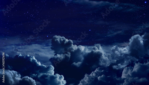 beautiful starry night sky with large clouds