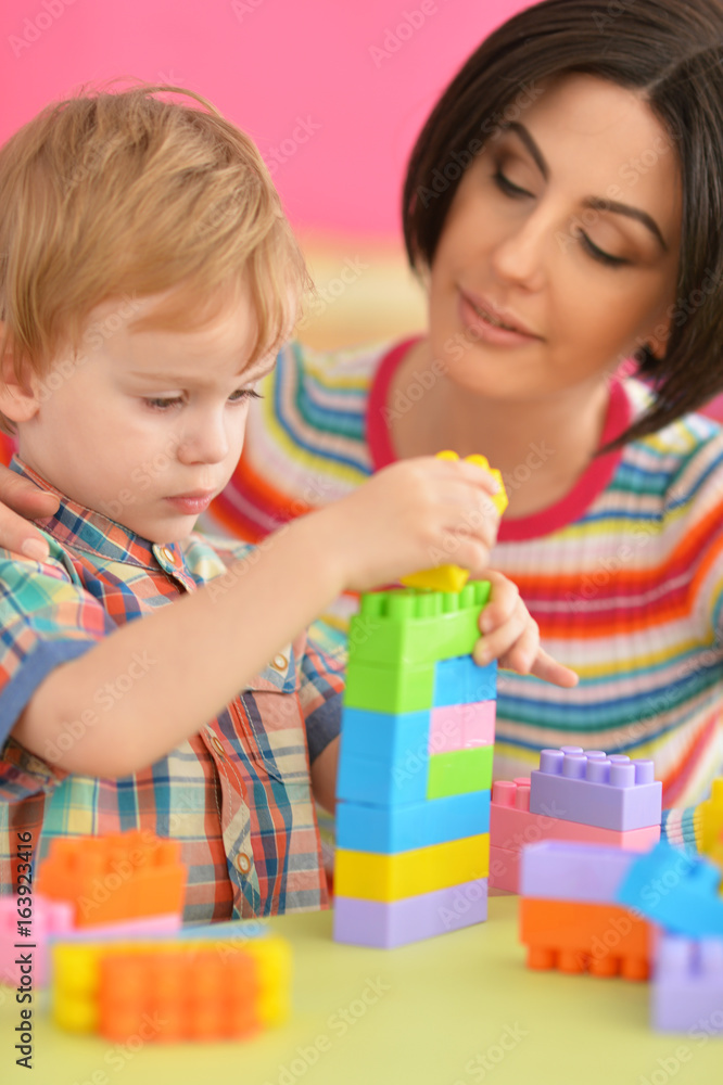 Young mother playing with son Young mother playing with son