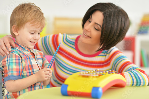 Young mother playing with son