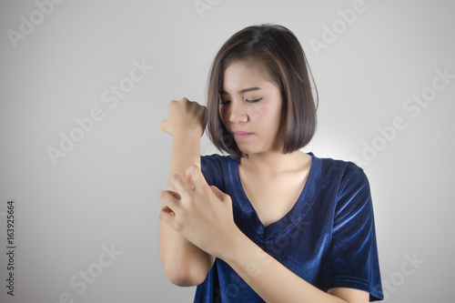 Women scratch the itch with hand, arm