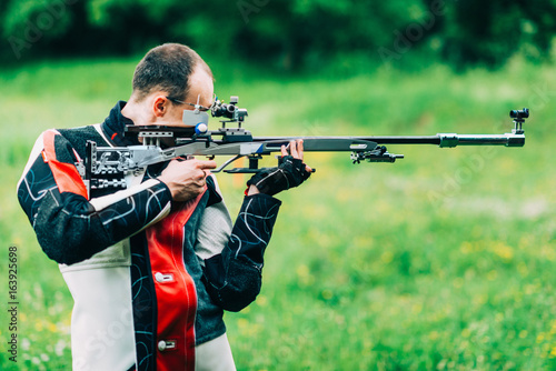 Man practicing for competition sport shooting with free rifle