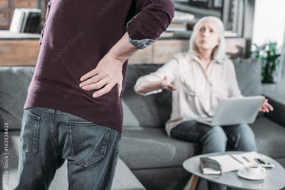 cropped shot of man suffering from strong back pain cropped shot of man suffering from strong back pain