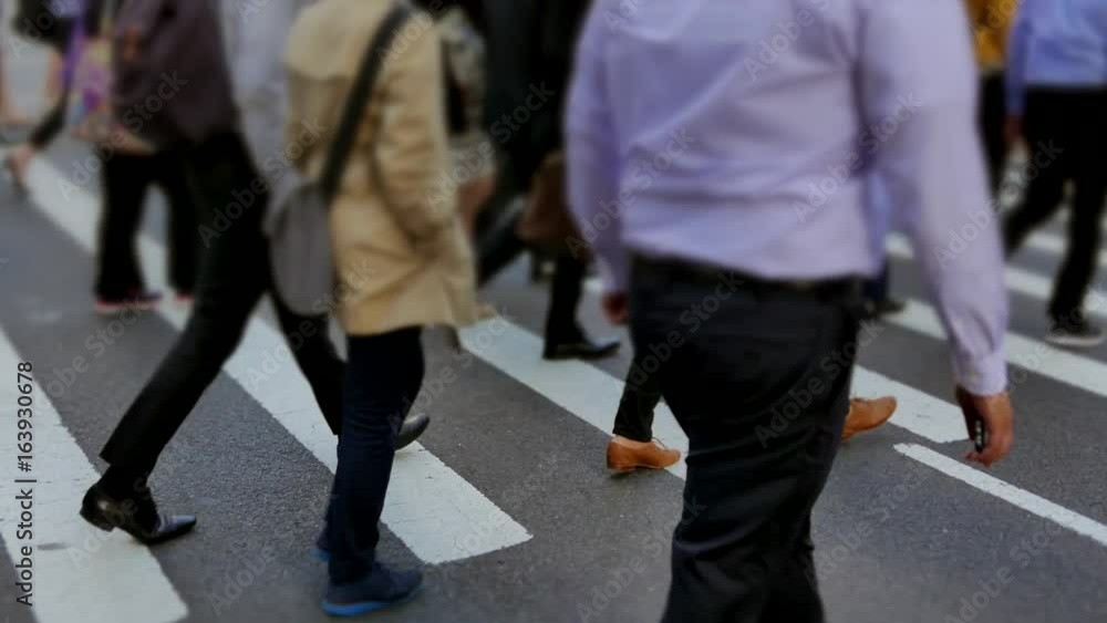 crowd of people walking in the city commuting through business district crowd of people walking in the city commuting through business district