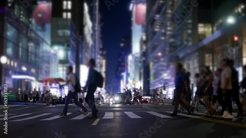crowd of people walking on busy street commuting through the city metropolis 