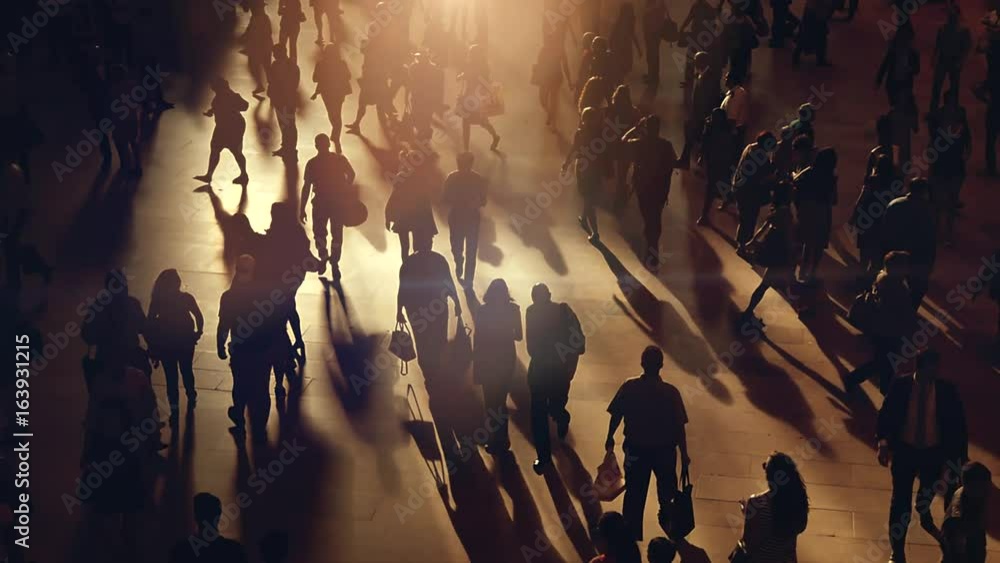 crowd of people walking on busy street commuting through the city metropolis 