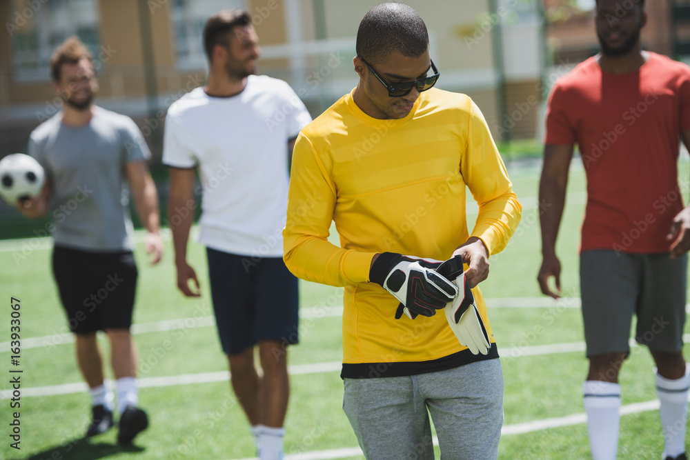multiethnic group of soccer players walking on pitch before soccer match multiethnic group of soccer players walking on pitch before soccer match