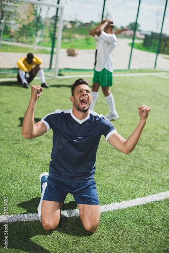 happy soccer player celebrating goal during soccer match