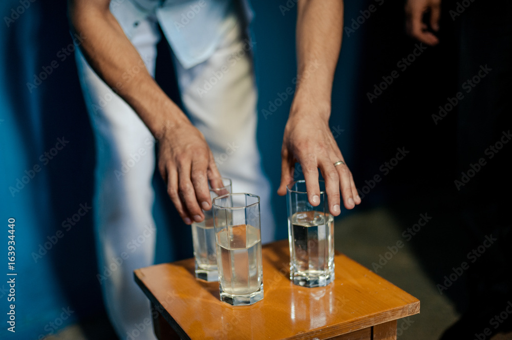 Many glasses on a table with alcohol and without