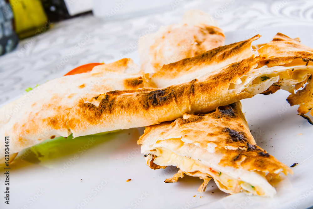 Roasted rolls of bread lavash filled with cheese and herbs Roasted rolls of bread lavash filled with cheese and herbs