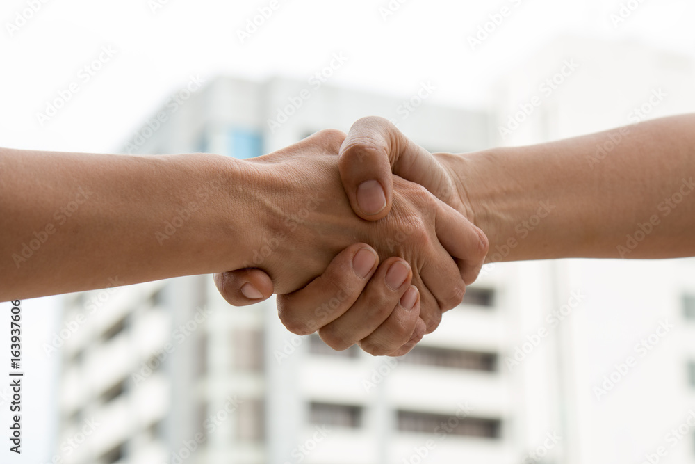 Close up of Partner shaking hand after business deal Close up of Partner shaking hand after business deal