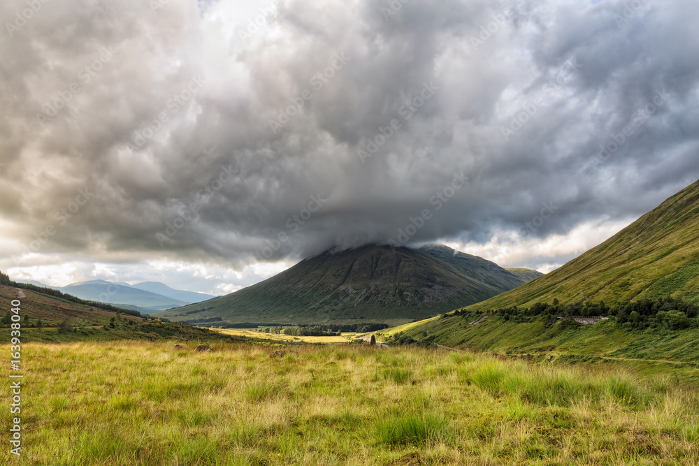 A valley in Scotland including Beinn Dorain and Beinn Odhar Mountains. A valley in Scotland including Beinn Dorain and Beinn Odhar Mountains.