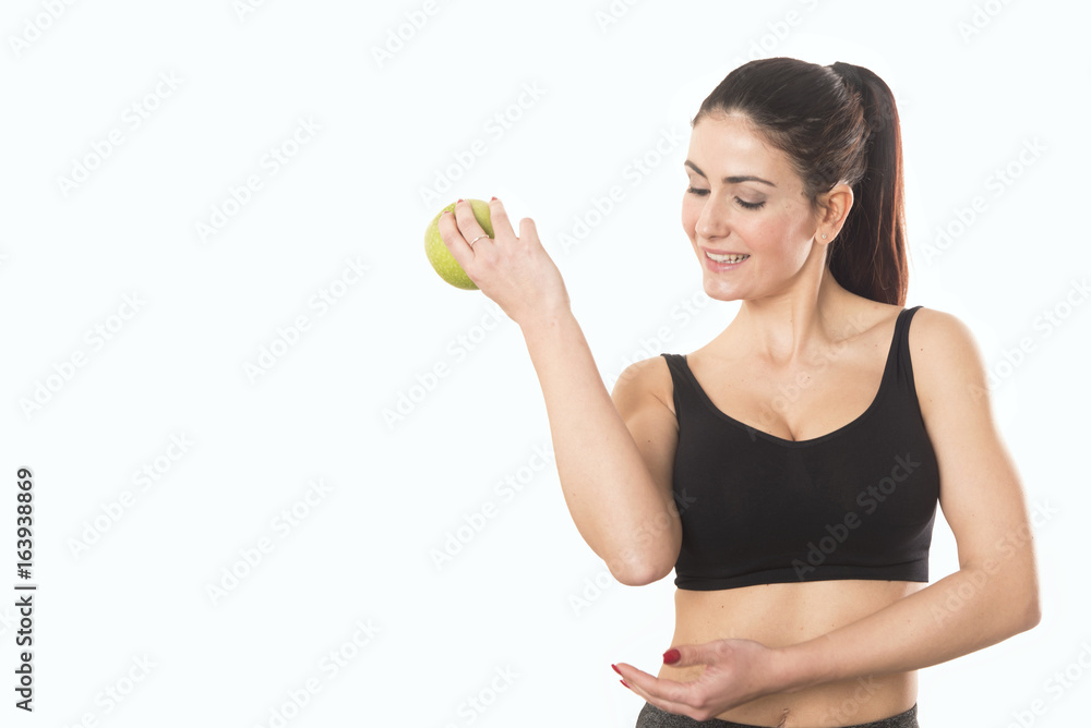Young caucasian woman holding apple. Fitness and diet concept. Healthy lifestyle Young caucasian woman holding apple. Fitness and diet concept. Healthy lifestyle