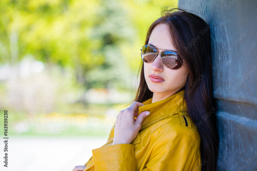 Portrait of a young beautiful brunette in mirrored sunglasses Portrait of a young beautiful brunette in mirrored sunglasses