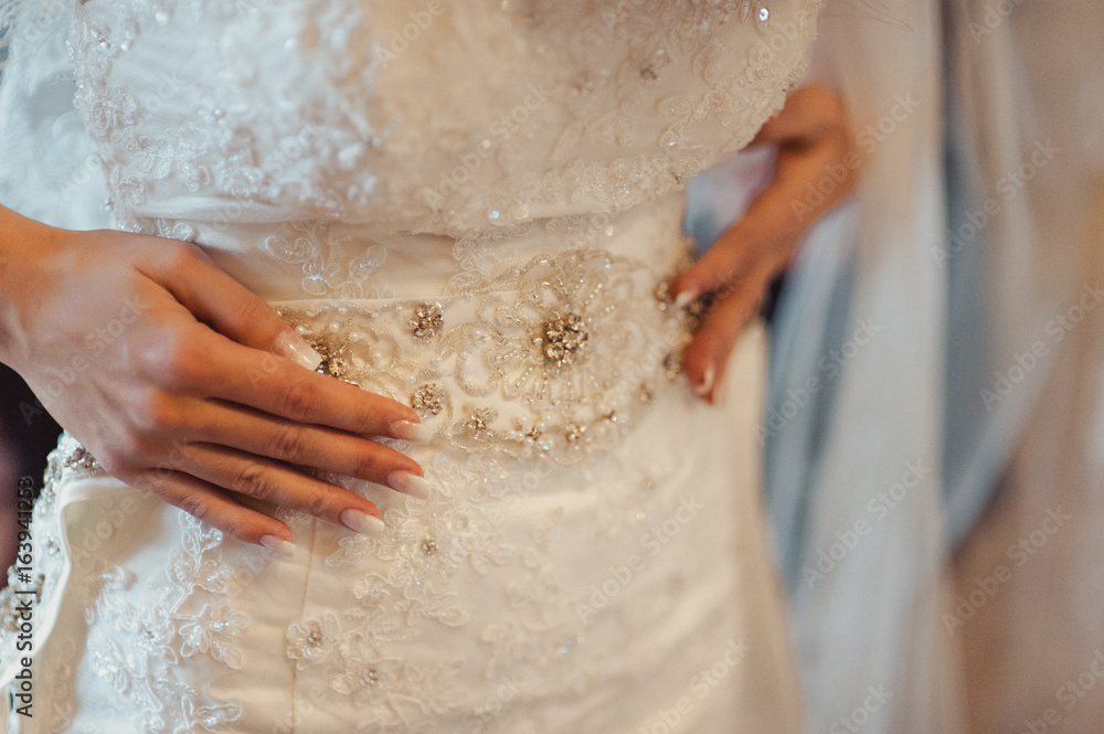 Fashionable bridesmaids dresses helped wear bow on back of wedding dress bride. Morning wedding day. Fashionable bridesmaids dresses helped wear bow on back of wedding dress bride. Morning wedding day.