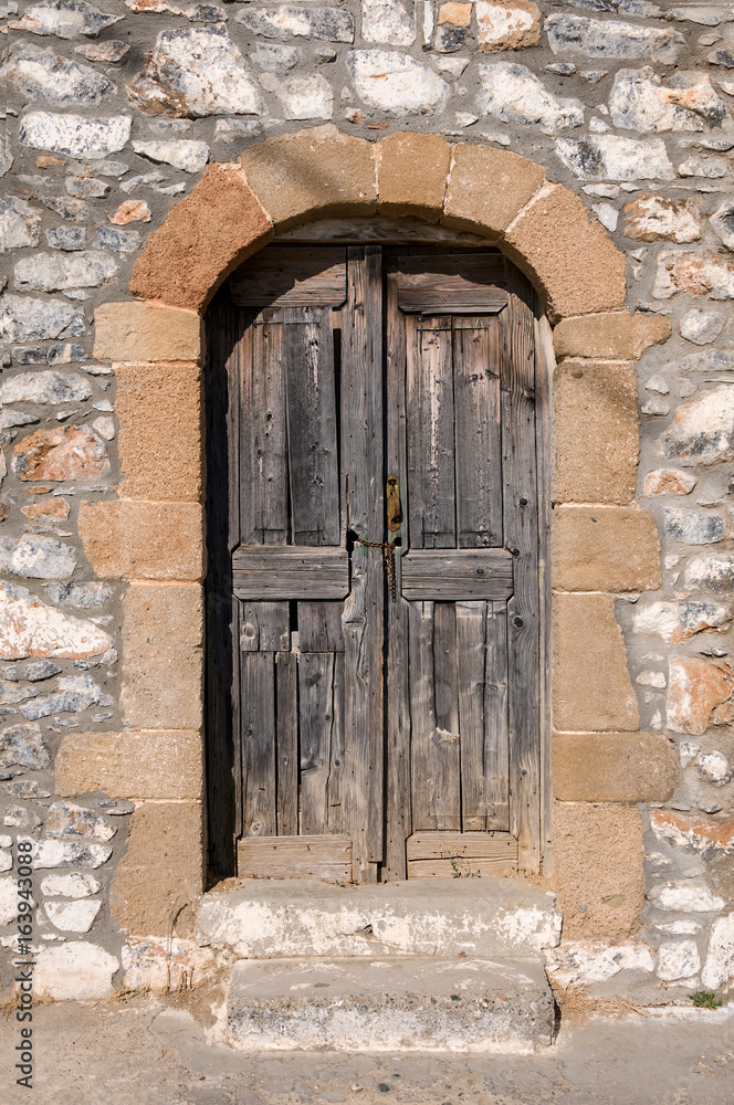 old wooden door in the stone wall old wooden door in the stone wall