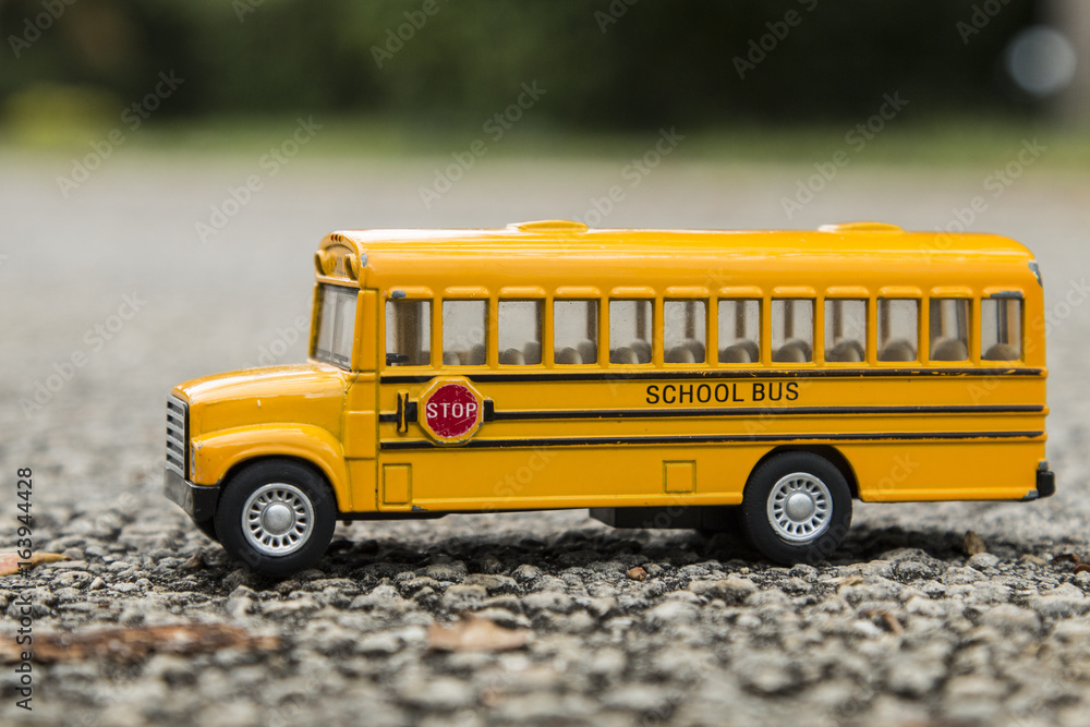 School bus yellow toy on asphalt road 