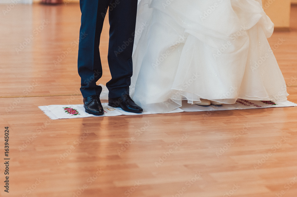 Fototapeta premium The couple is standing on an embroidered towel