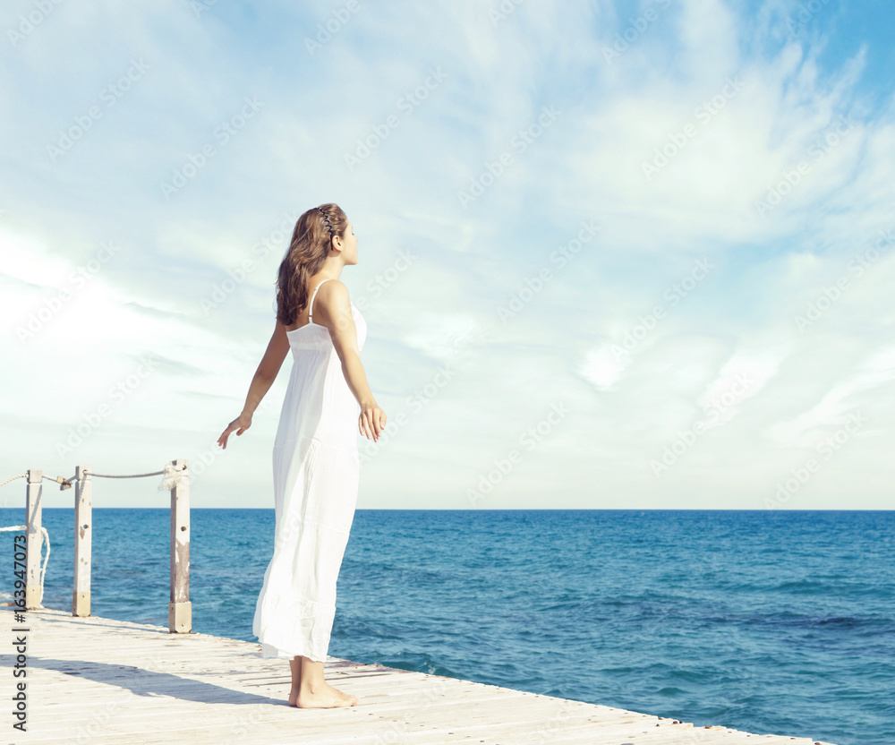 Young, beautiful and healthy girl on wooden pier at summer. Vacation, resort, traveling and tourism concept. Young, beautiful and healthy girl on wooden pier at summer. Vacation, resort, traveling and tourism concept.