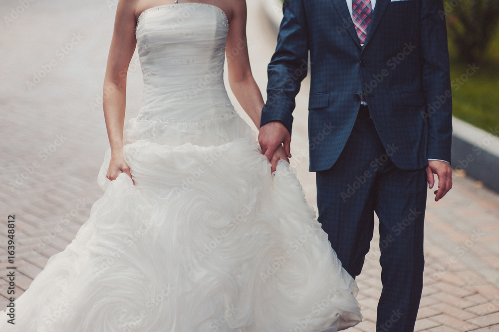 Holding hands. Closeup view of married couple holding hands Holding hands. Closeup view of married couple holding hands