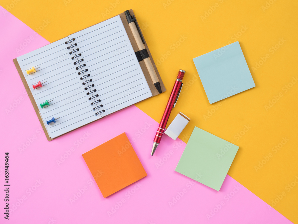 Flat Lay Stationary on Pink and yellow background Flat Lay Stationary on Pink and yellow background