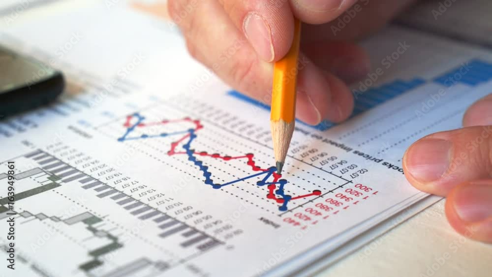 Businessman checking financial report and charts in the office at the workplace. Close view and very smooth dolly shot. 4K video with shallow depth of field focus on hands. Businessman checking financial report and charts in the office at the workplace. Close view and very smooth dolly shot. 4K video with shallow depth of field focus on hands.