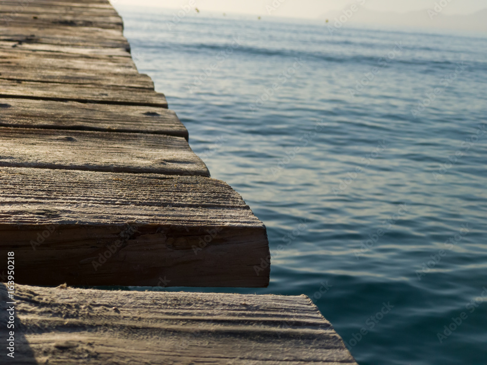 Natural background, beatiful wooden pier close-up and sea water