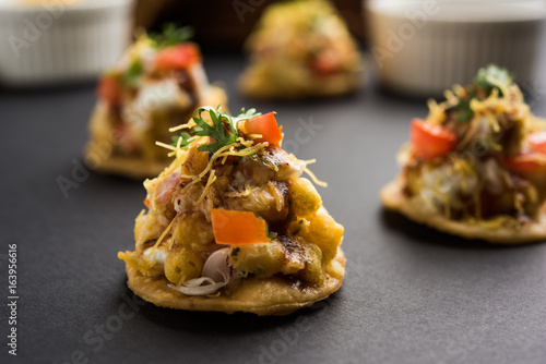 Sev Btata Puri / sev puri / papdi chat - popular indian snacks item  - Indian street food, selective focus
 photo