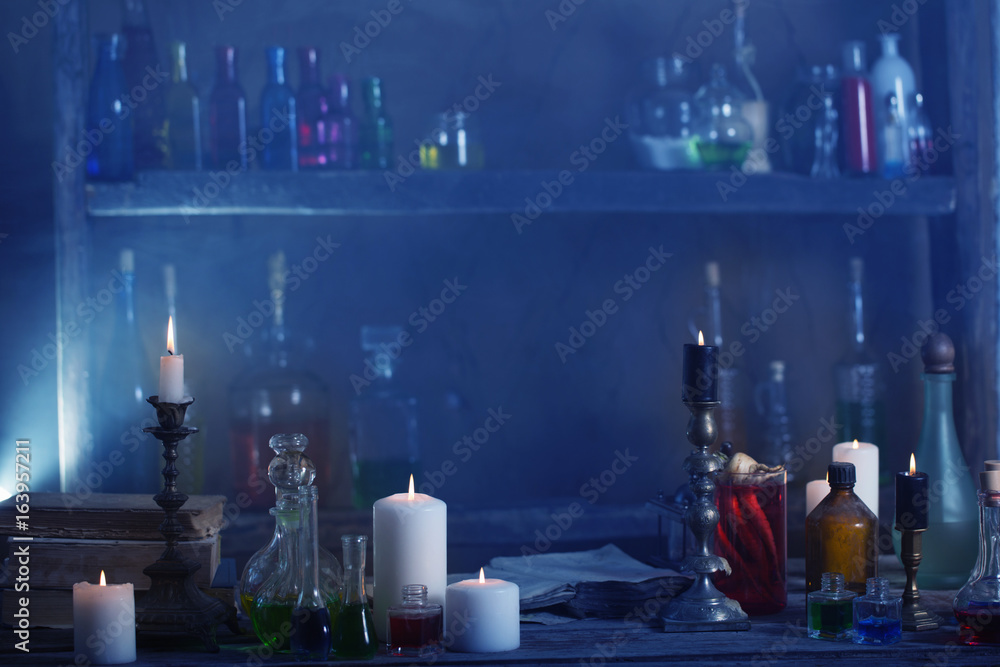 Magic potion, ancient books and candles Magic potion, ancient books and candles