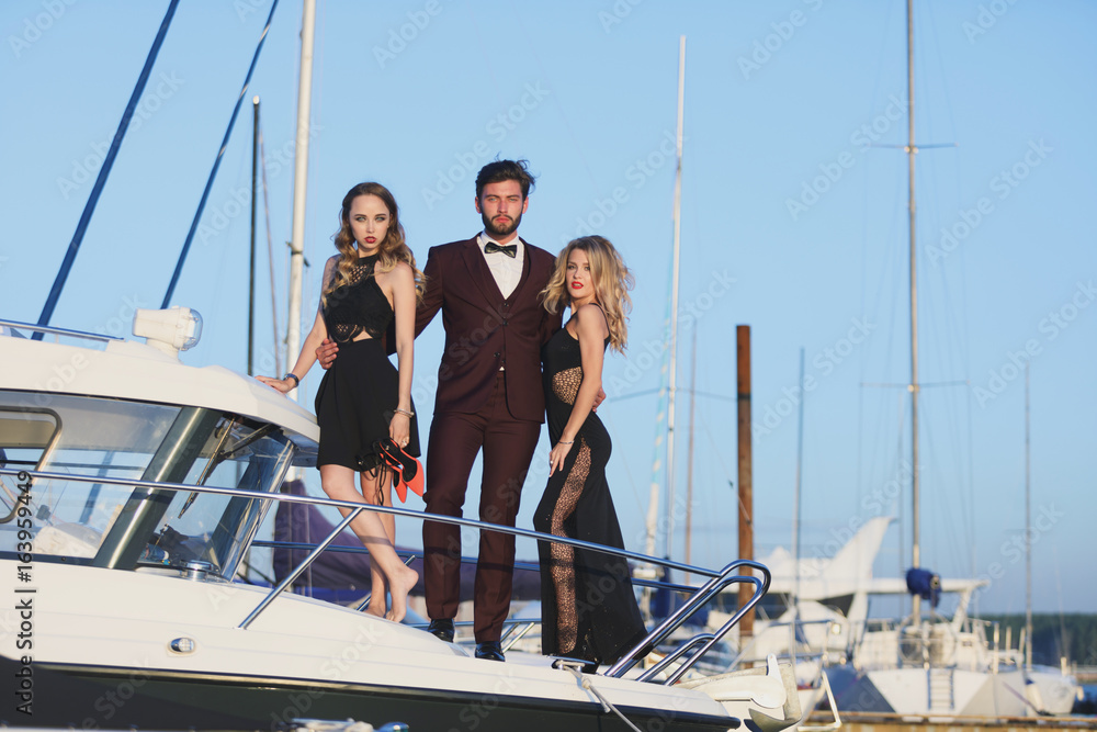 Group Of Young Friends Relaxing On A Boat Enjoying Sunny Day Group Of Young Friends Relaxing On A Boat Enjoying Sunny Day