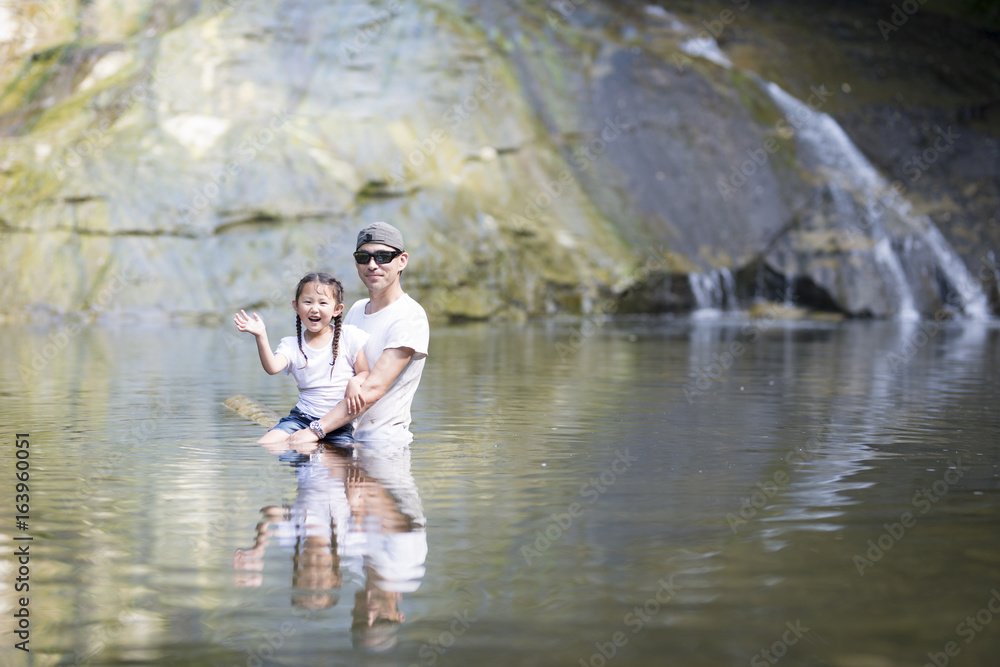 Fototapeta premium Father and daughter playing in the river