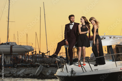 Stylish wealthy friends having fun on a luxury yacht © Gennady Danilkin