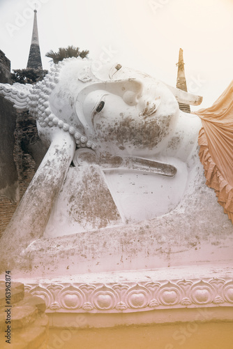 Ancient white Reclining  Buddha statues and ruined pagoda at Wat Yai Chai Mongkhol in Ayutthaya historic attractions , Thailand. photo