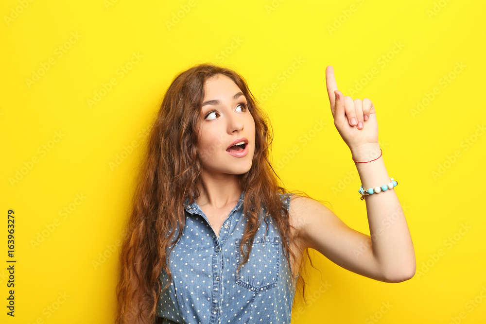 Portrait of young woman on yellow background Portrait of young woman on yellow background