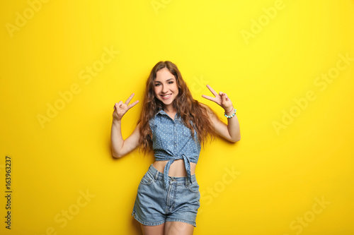 Portrait of young woman on yellow background © 5second