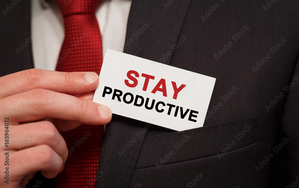 Businessman putting a card with text Stay Productive in the pocket Businessman putting a card with text Stay Productive in the pocket