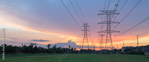 Fotografering Group silhouette of transmission towers (power tower, electricity pylon, steel lattice tower) at twilight in US
