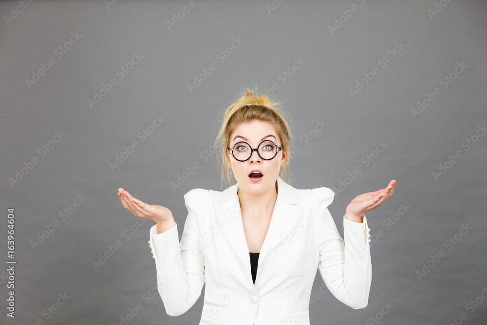 Confused office worker woman gesturing with hands Confused office worker woman gesturing with hands