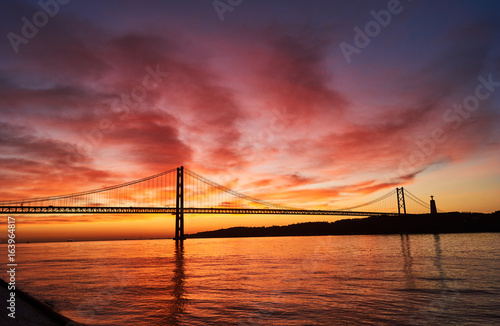 clouds on fire on a sunrise in Lisbon  Portugal  with the April 25th Bridge