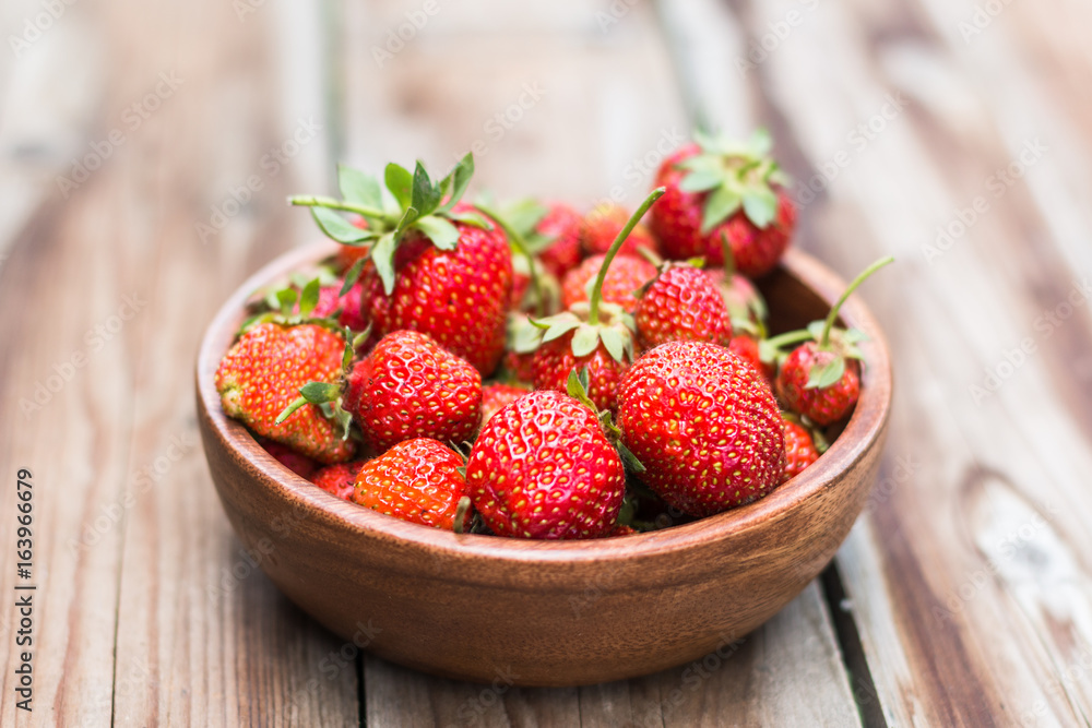 wooden bowl full of fresh strawberries on thewooden background wooden bowl full of fresh strawberries on thewooden background