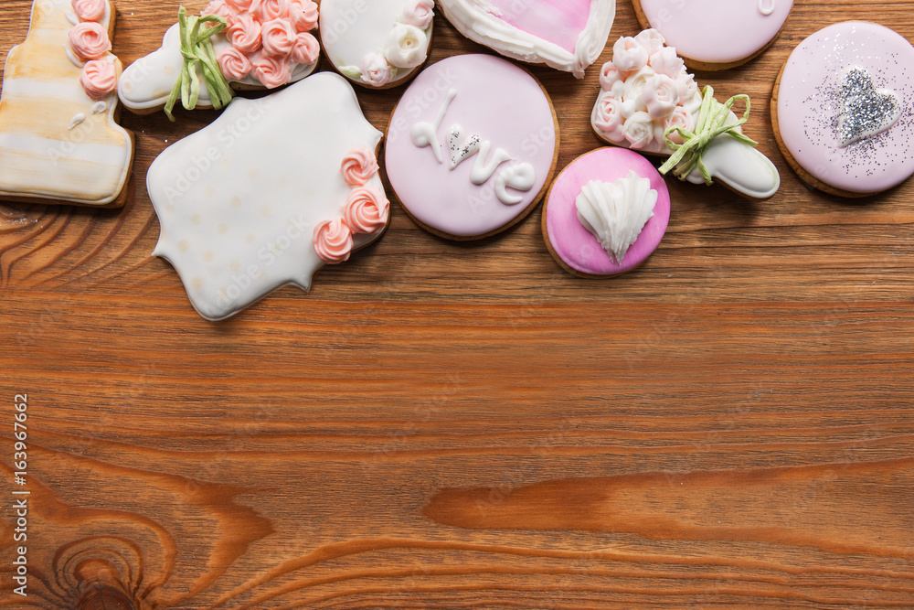Beautiful gingerbread with free space. Bakery products in frame, wedding present, beautiful cookies on wooden background. Sweets, love concept Beautiful gingerbread with free space. Bakery products in frame, wedding present, beautiful cookies on wooden background. Sweets, love concept
