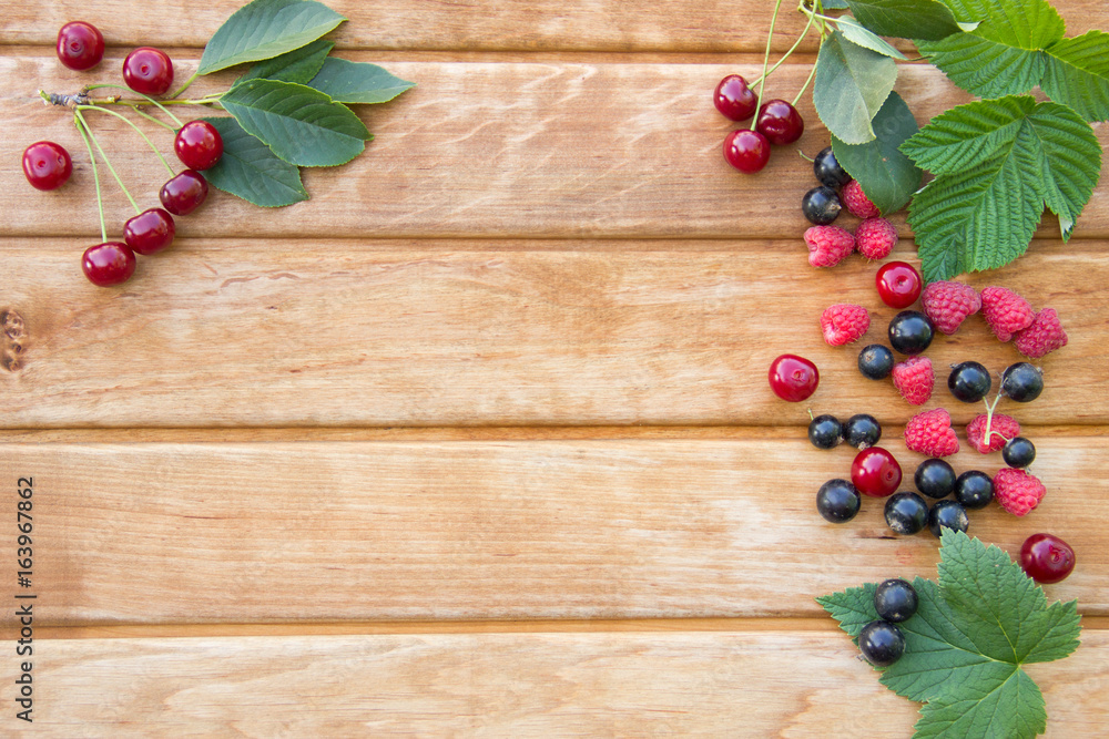 Berries on Wooden Background. Raspberries, Blueberry and Cherry. Summer or Spring Organic Berry over Wood.