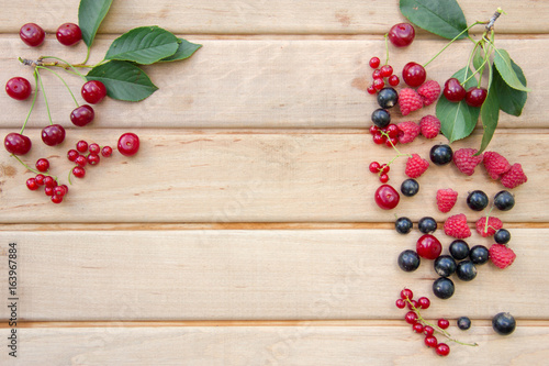 Berries on Wooden Background. Raspberries, Blueberry and Cherry. Summer or Spring Organic Berry over Wood.