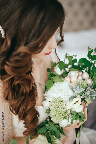 Bride with a beautiful bouquet of different colors. Close-up