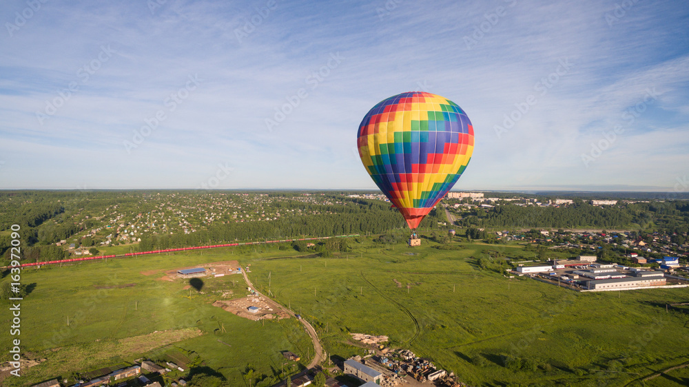Fototapeta premium Rainbow aerostat over village