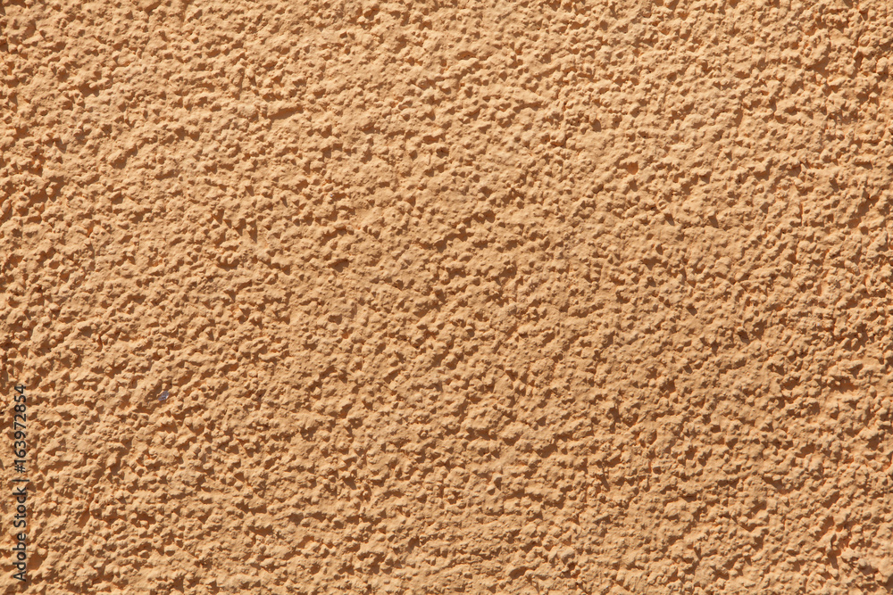 Orange painted stucco wall. Background texture Orange painted stucco wall. Background texture