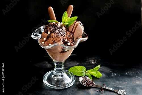 Chocolate ice cream in a cup on a black background