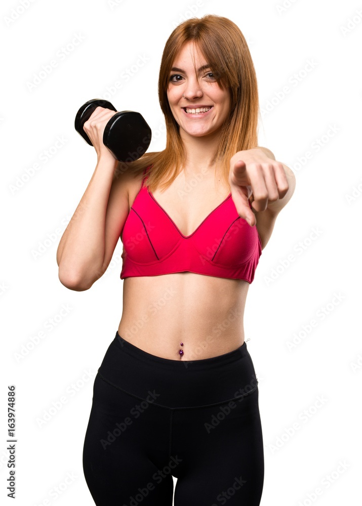 Beautiful sport woman with dumbbells pointing to the front Beautiful sport woman with dumbbells pointing to the front