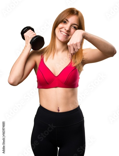 Beautiful sport woman with dumbbells pointing down